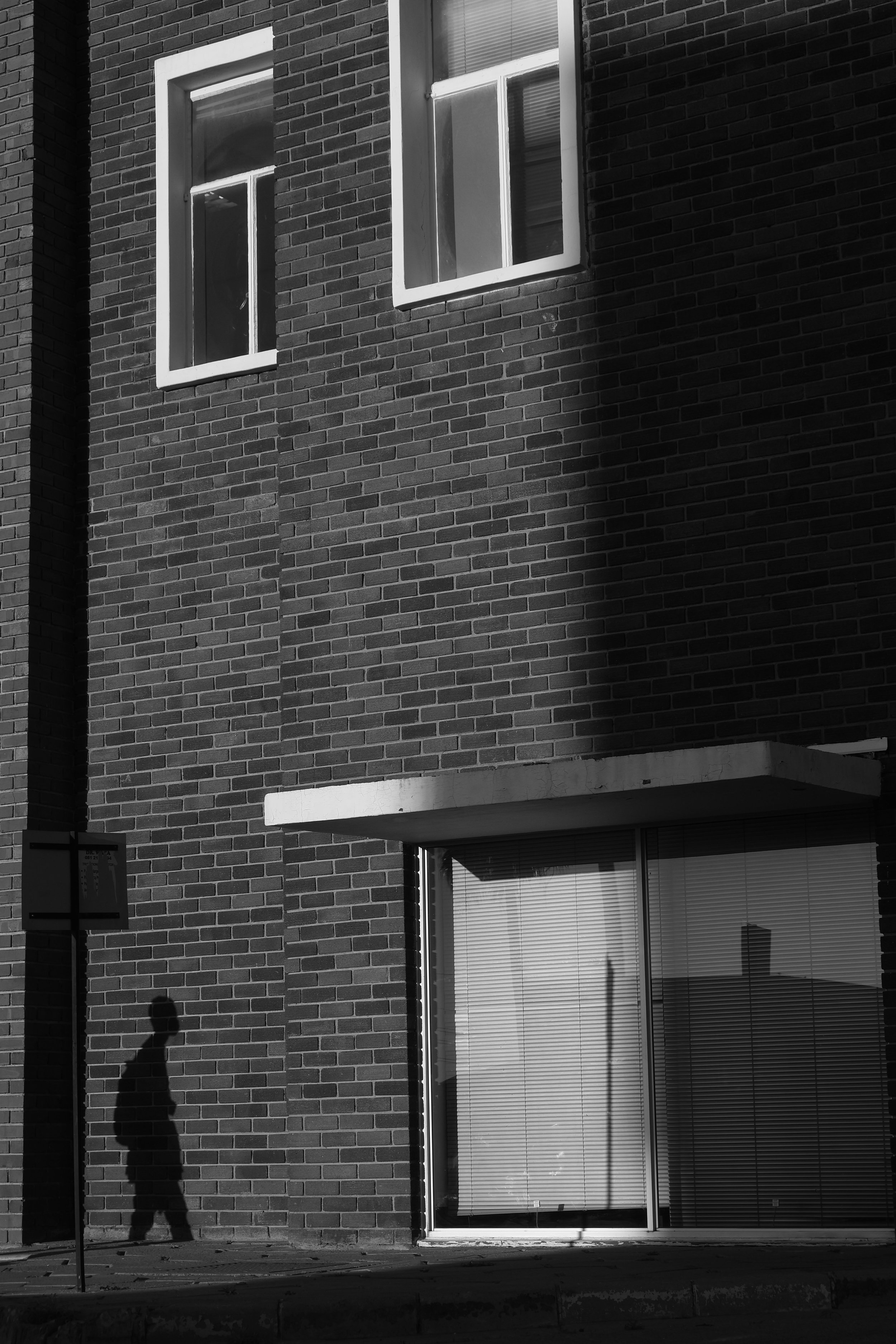 A photograph of a walking shadow in Windhoek, Namibia