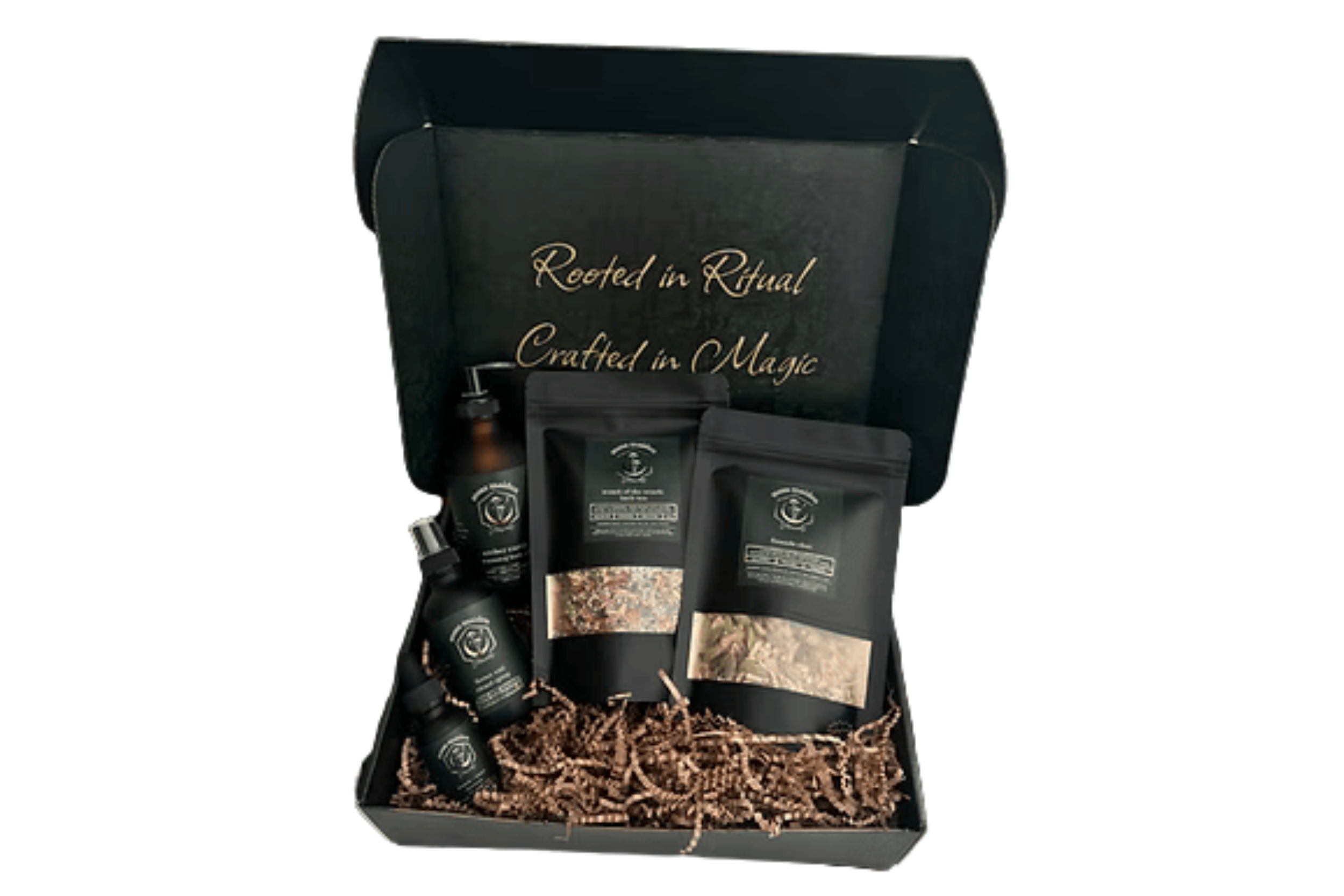 A gift box containing skincare products, including bottles and packets, with the phrase 'Rooted in Ritual, Crafted in Magic' written on the inside lid.