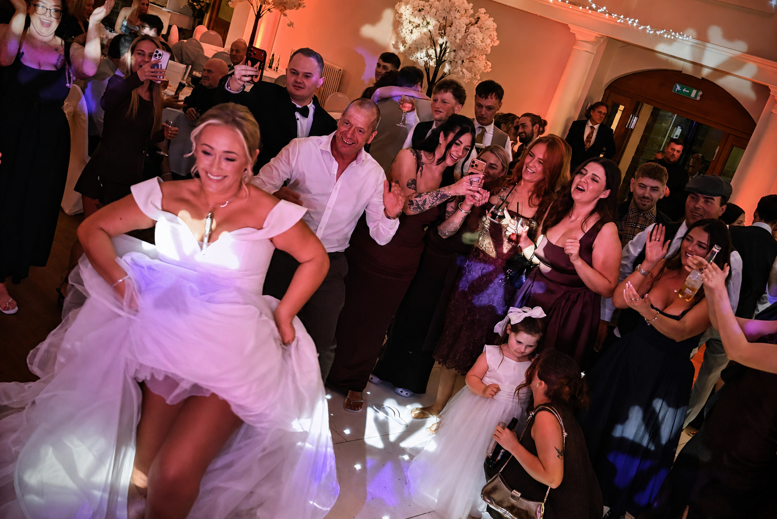Bride dancing with guests on a full wedding dancefloor at a Yorkshire venue.