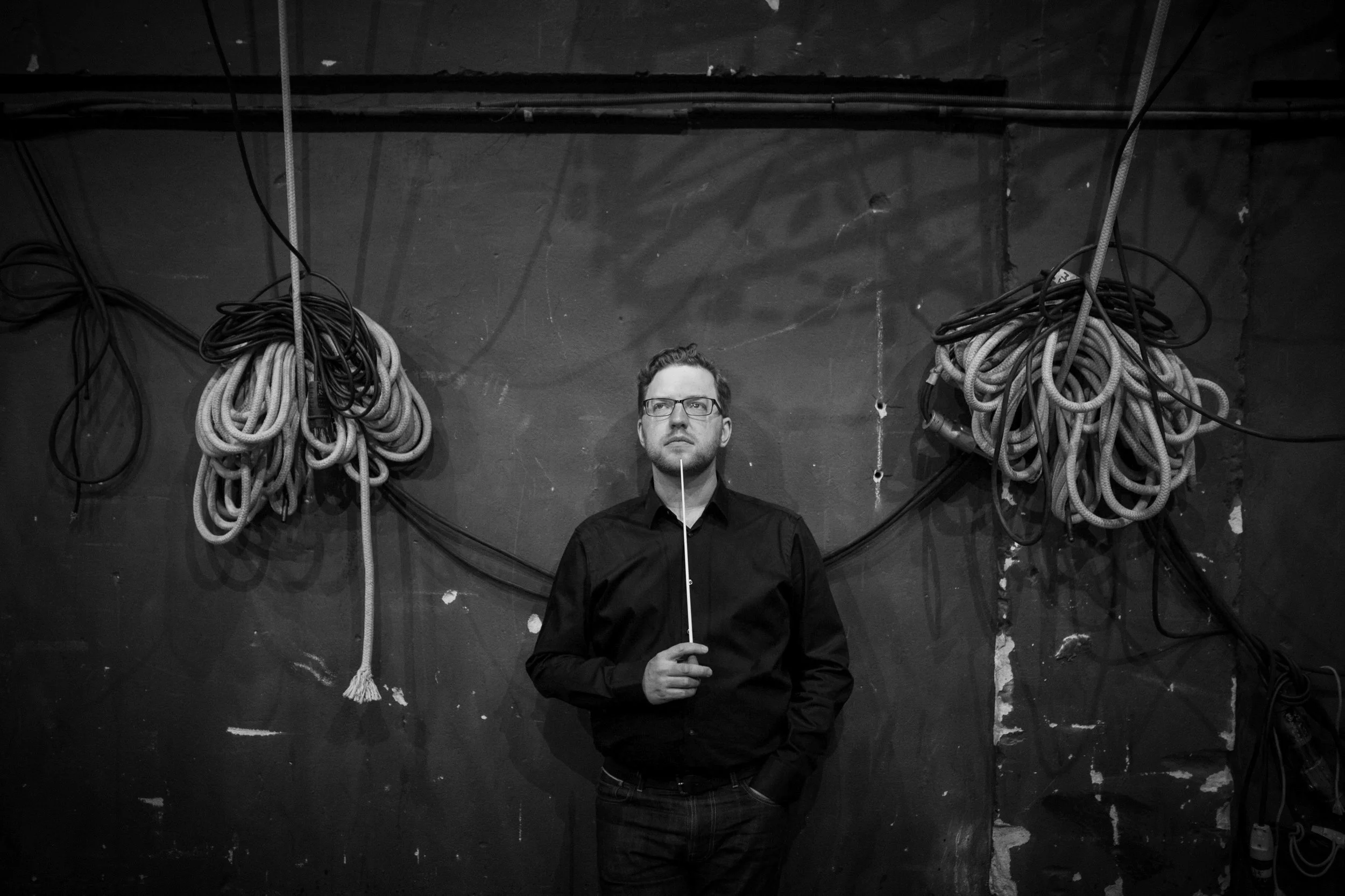 Black-and-white photo of Benjamin Bayl on theater stage
