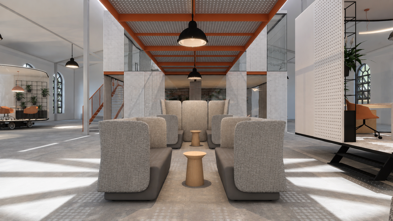 Strefa wypoczynku pod pomarańczową kładką w industrialnym wnętrzu coworkingu
