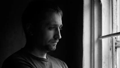 A person standing by a window
