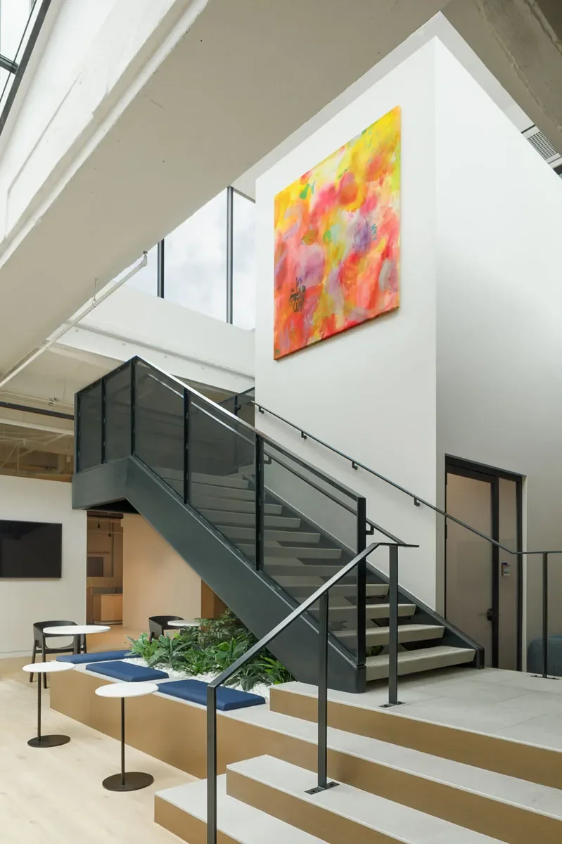 Artwork above staircase in multi-level office space