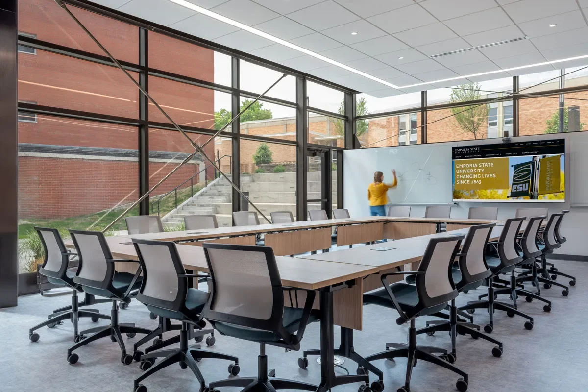 Conference room with full wall window light office chairs