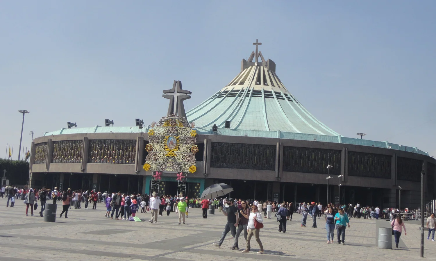 The modern Basilica of Our Lady of Guadalupe in Mexico City, with its broad green roof facing the plaza.