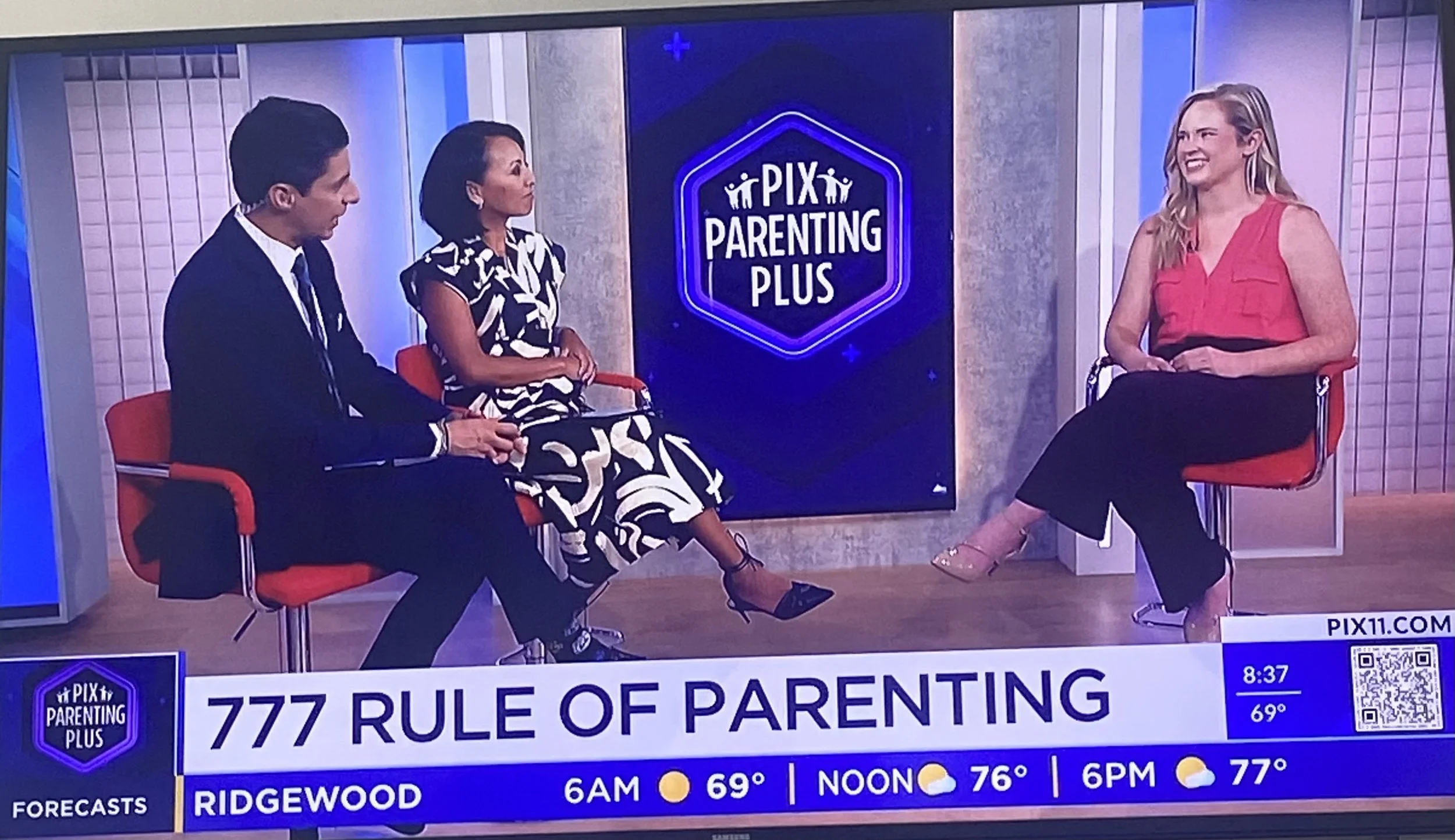 Three people sitting on a television set for a talk show called 'PIX Parenting Plus'. A man in a suit, a woman in a patterned dress, and a woman in a pink top are engaged in conversation. The show's logo is displayed in the background, and a weather forecast is shown at the bottom of the screen.