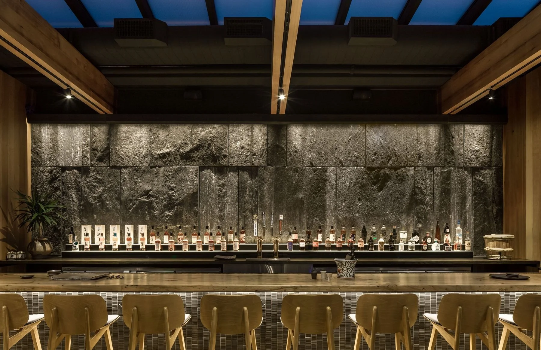 The gneiss stone wall behind the den bar.