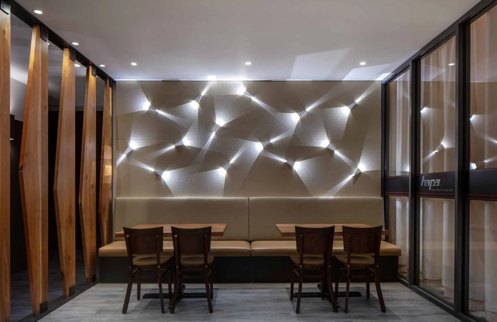 Acoustic baffles and the light wall enhance the design while improving the dining experience.