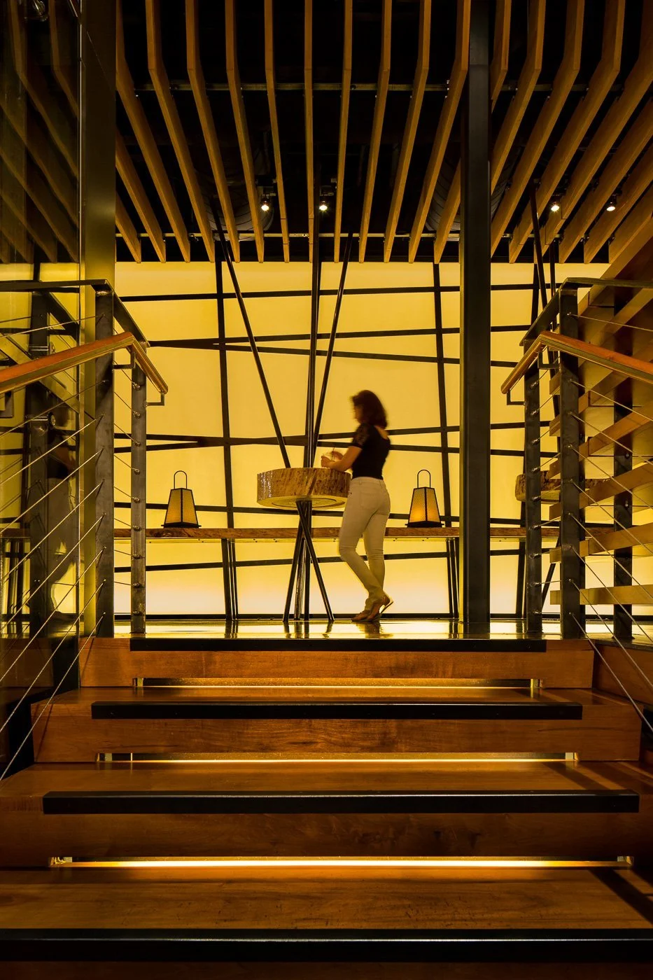 The stair climbs inside a screen of bamboo between the two floors.