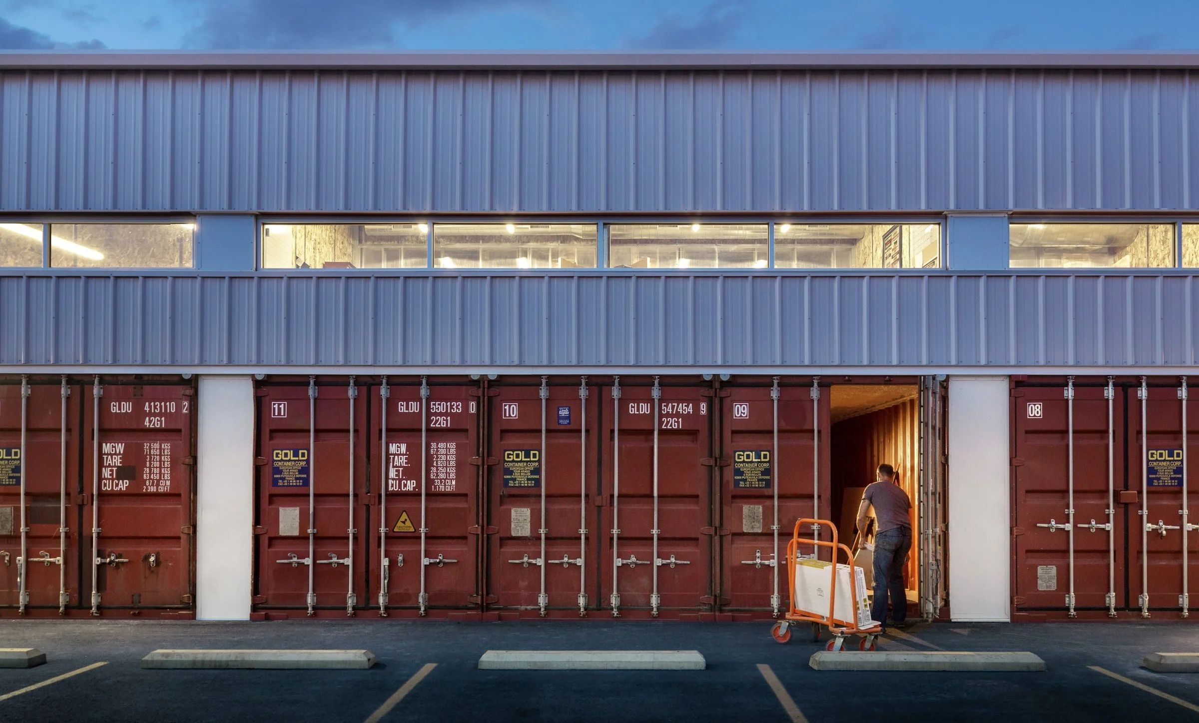 Shipping containers provide secure member storage and became a structural element of the design.