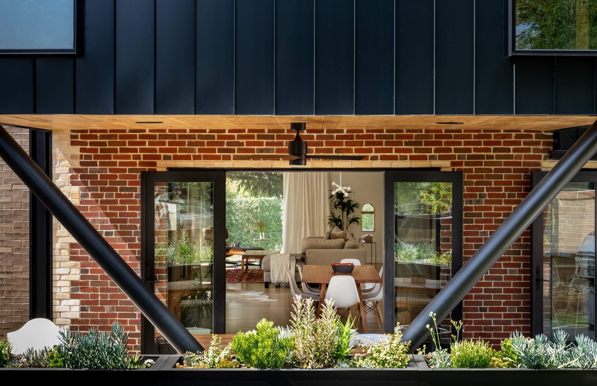Kitchen and dining are mirrored outside beneath the cantilever.
