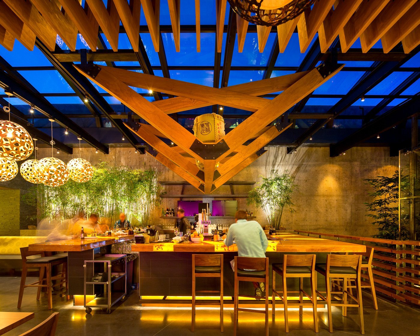 The rooftop bar beneath the trellis, lit red at night.
