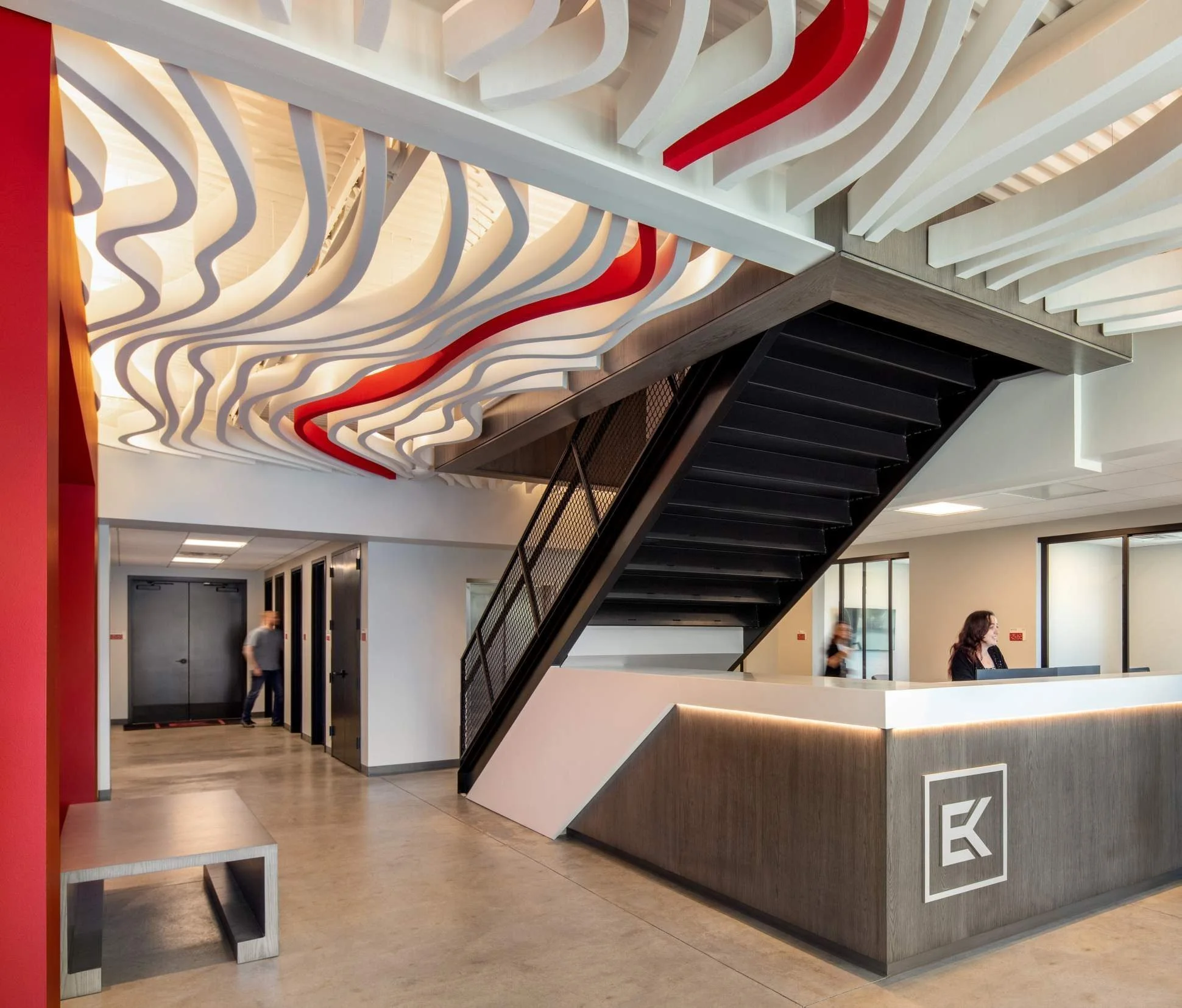 The lobby doubles as a showroom for the wall and ceiling systems E&K installs.