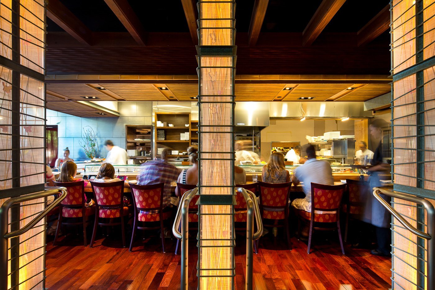 Through the lattice screens to the open kitchen and dining beyond.