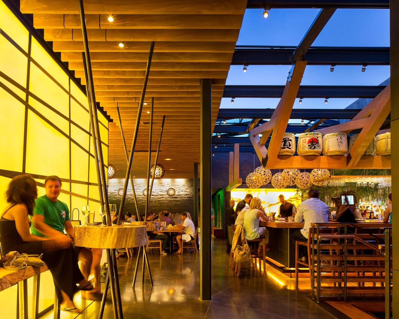 Bamboo poles and a wood trellis roof shape the second-floor dining room.