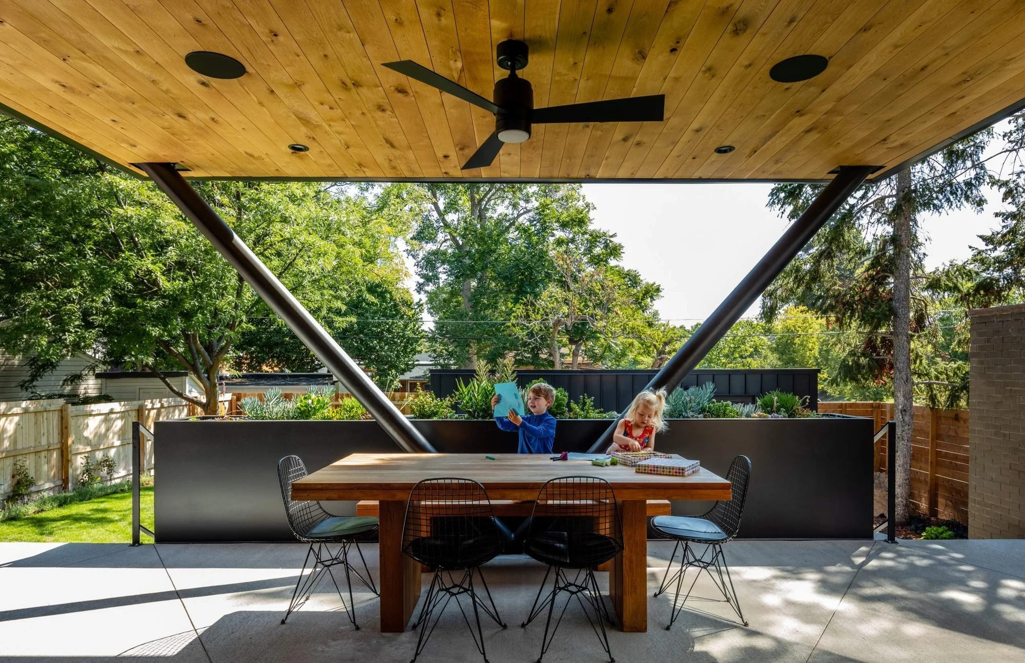 The outdoor kitchen and dining space extend the main floor into the yard.