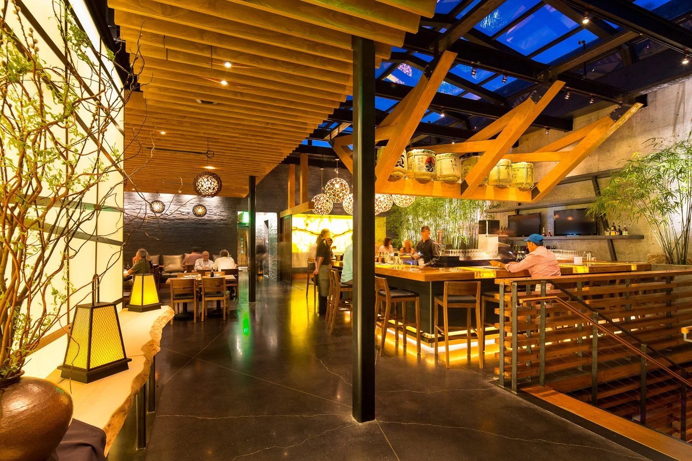 The open shared kitchen anchors the plan, with the bamboo garden running its length.