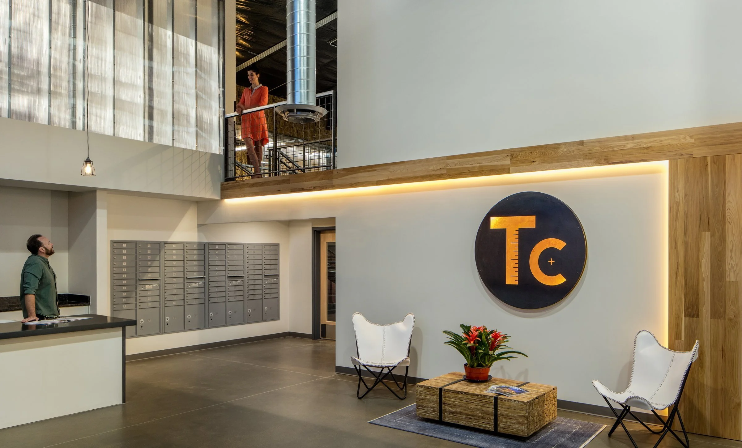 The double-height entry divides the member-only bullpen from the office space.