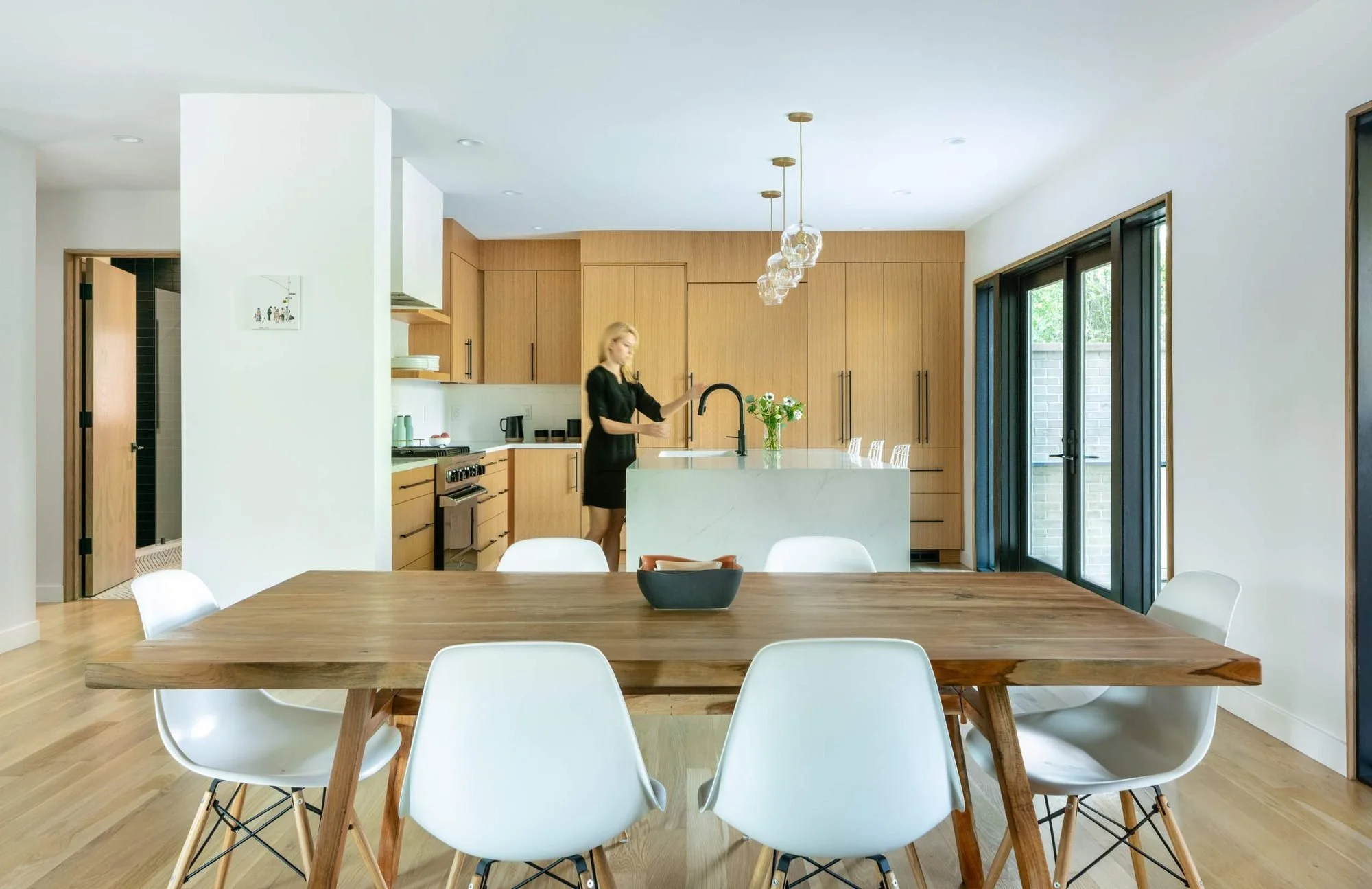 Crisp white drywall reflects daylight from floor-to-ceiling glazing.