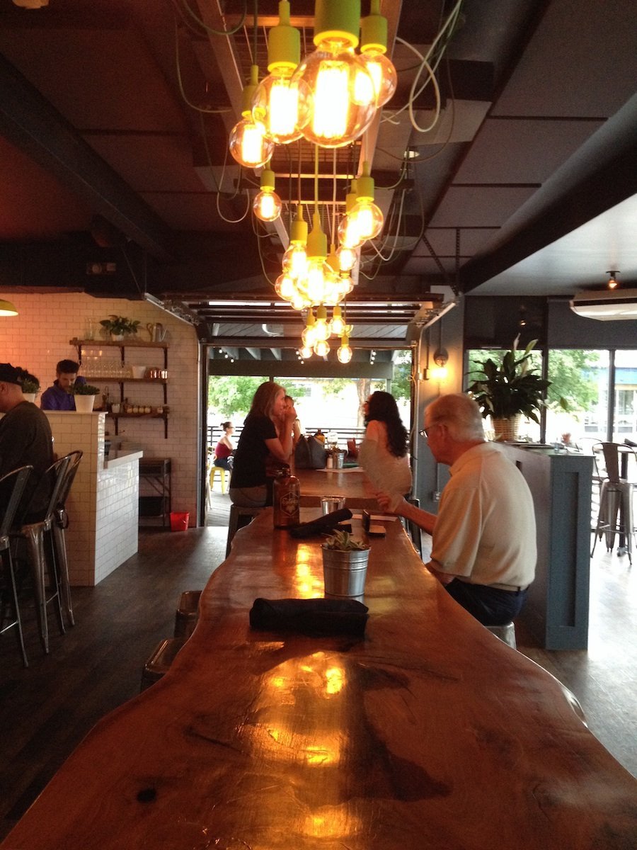 Warm light plays across the live-edge community table.