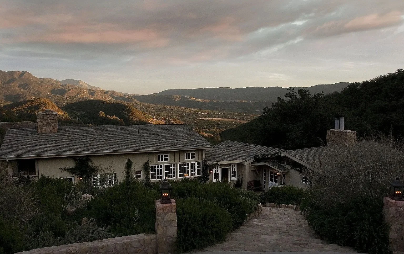 Ojai luxury home with views of the surrounding mountains at sunset