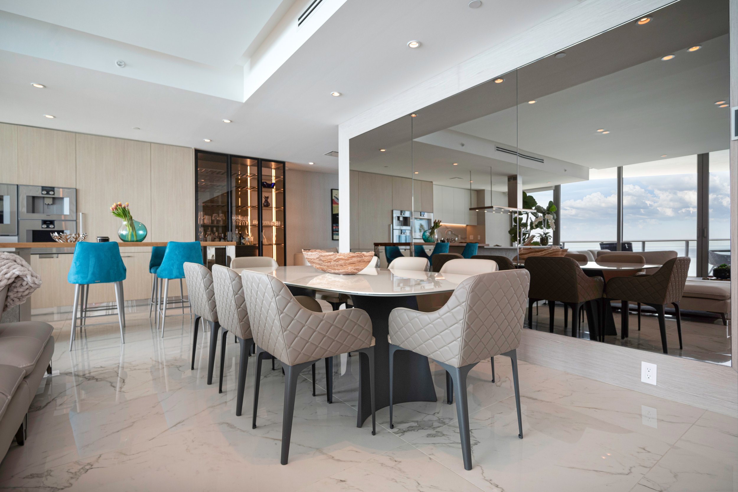 Elegant dining area at The Miami Beach EDITION, where delicate furnishings, warm wood wall paneling and soft neutral tones blend seamlessly together.