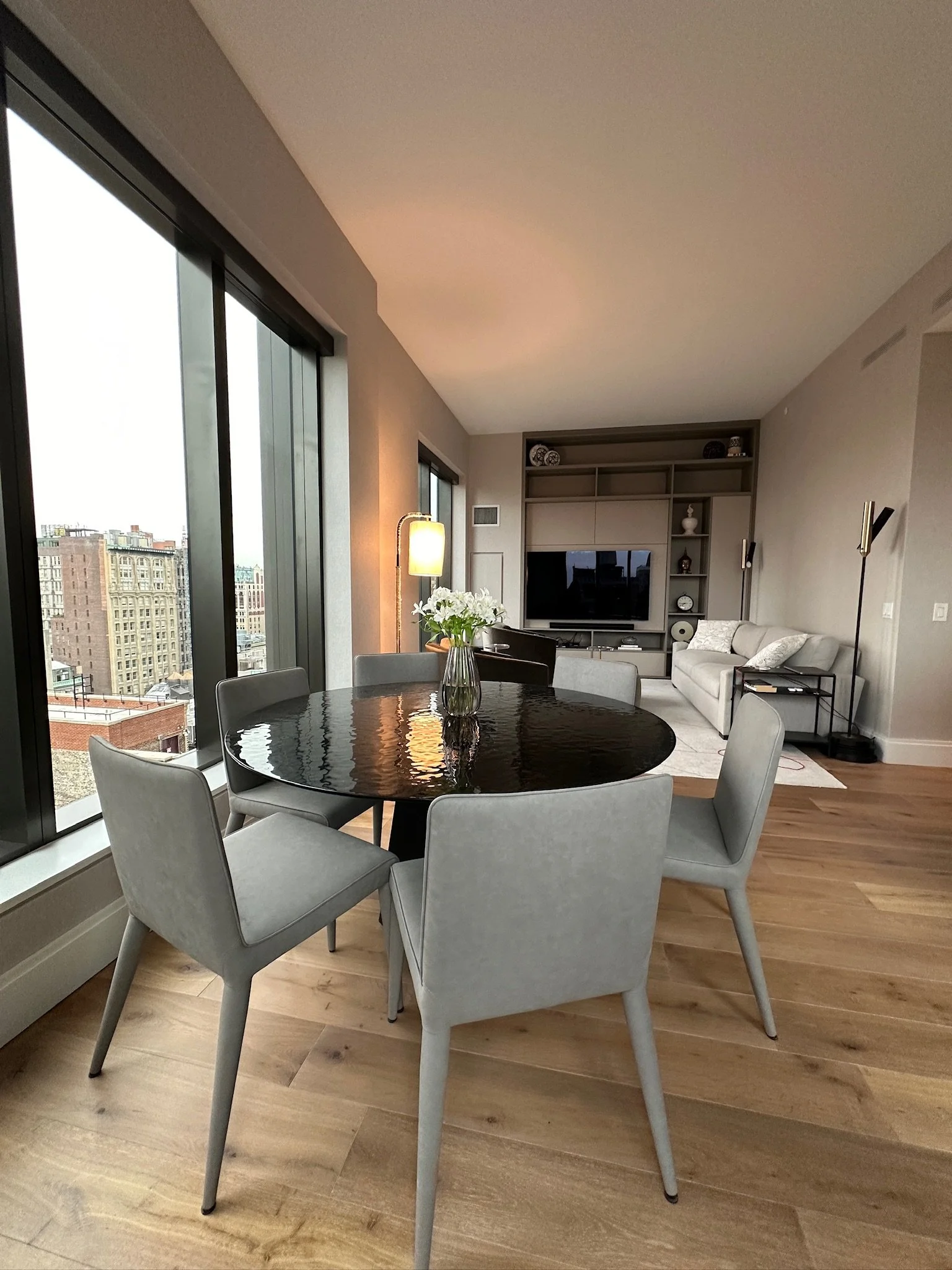 Contemporary living and dining interior at Rose Hill in Manhattan, featuring custom built-in cabinetry and a refined neutral palette.