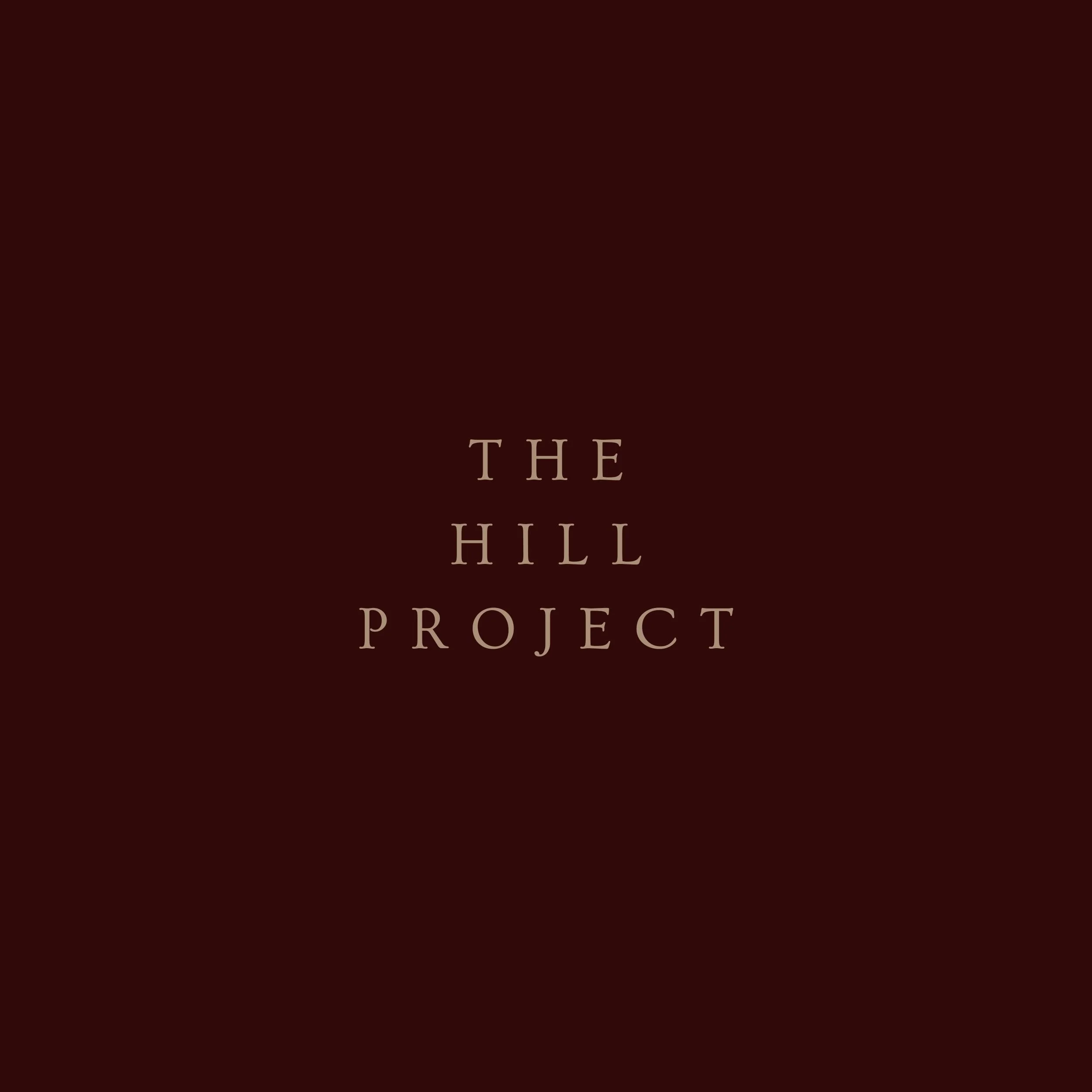 Dark brown background with the words 'The Hill Project' written in light brown text.