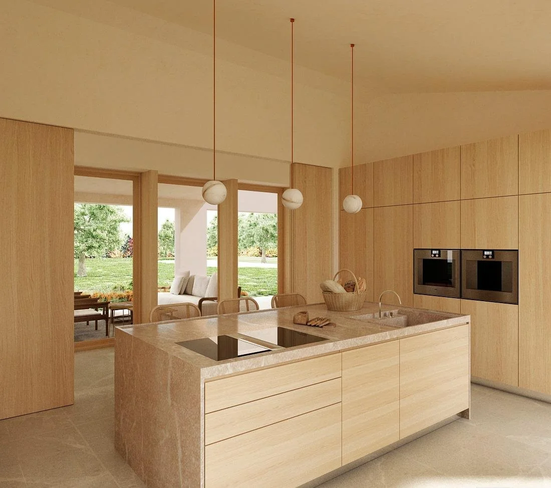 Cocina moderna con encimera de granito, armarios de madera clara, dos hornos empotrados y lámparas colgantes con esferas blancas.