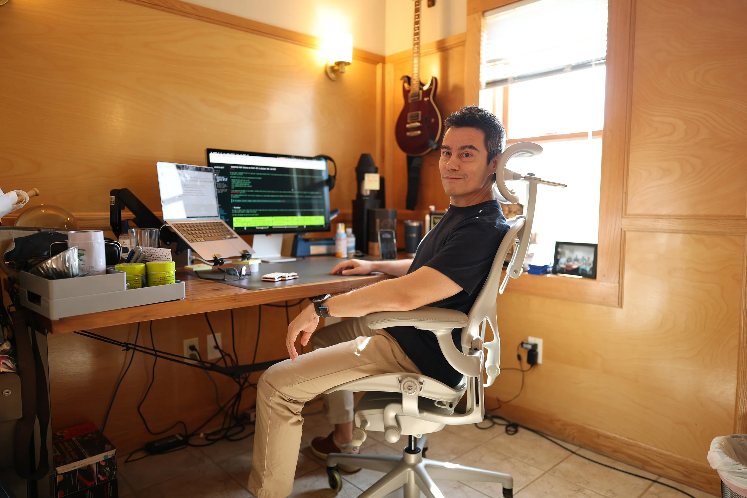 Lion Cave team member working at a multi-monitor workstation.