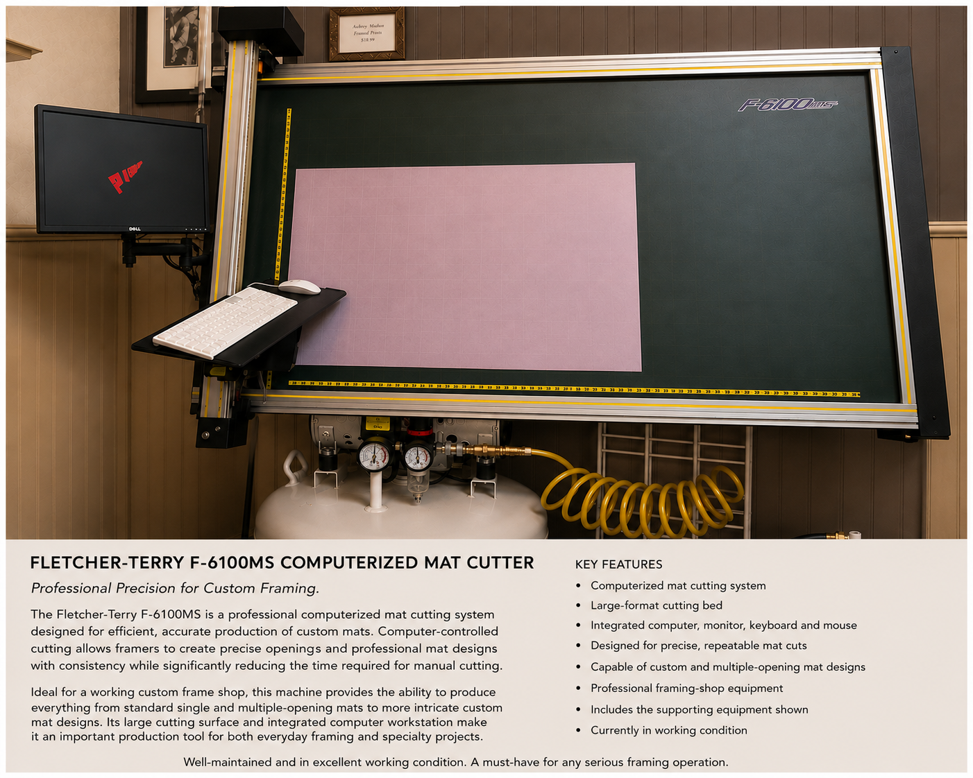 A Fletcher-Terry F-6100MS computerized mat cutter with a large cutting bed, a computer monitor, keyboard, mouse, and an air compressor with yellow coiled tubing. The mat cutter has a green cutting surface with a pink mat positioned on it.
