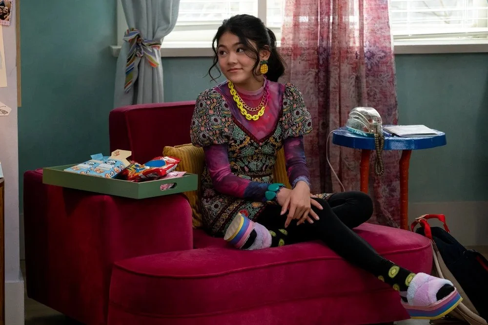 206_Claudia_sitting_red_chair_yellow_chain_necklace.jpeg