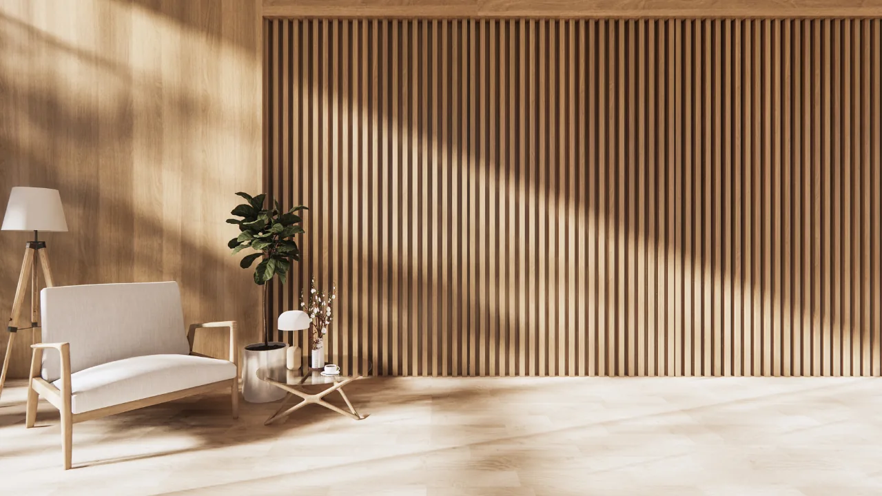 Office lobby with beige sofa, wooden side table, potted plant, and floor lamp, against a wooden slat wall.