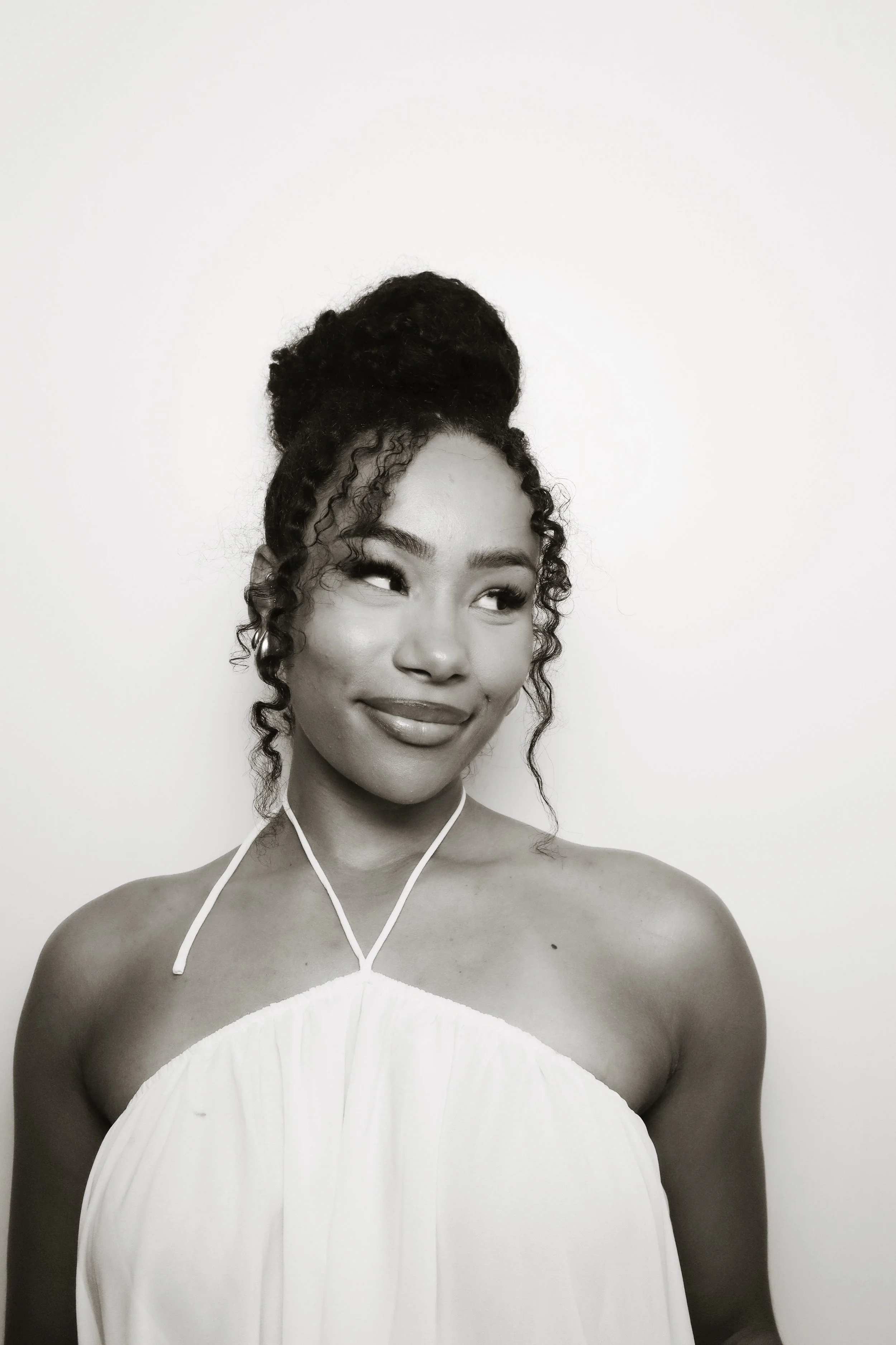 A woman in a formal white dress posing in a solo photo strip from 801 Booth's vintage photo booth