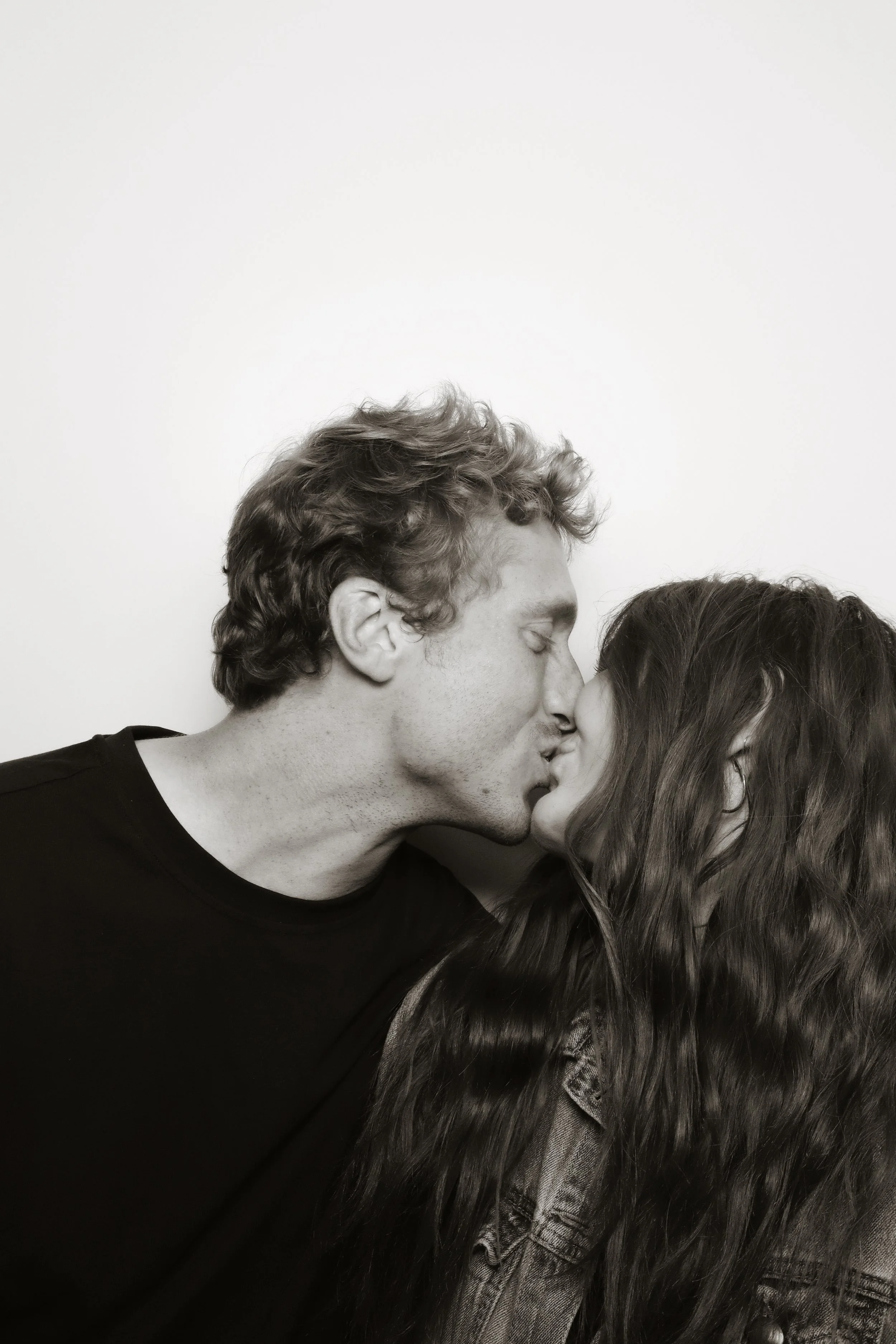 A couple sharing a kiss in a wedding photo strip from 801 Booth's vintage photo booth rental