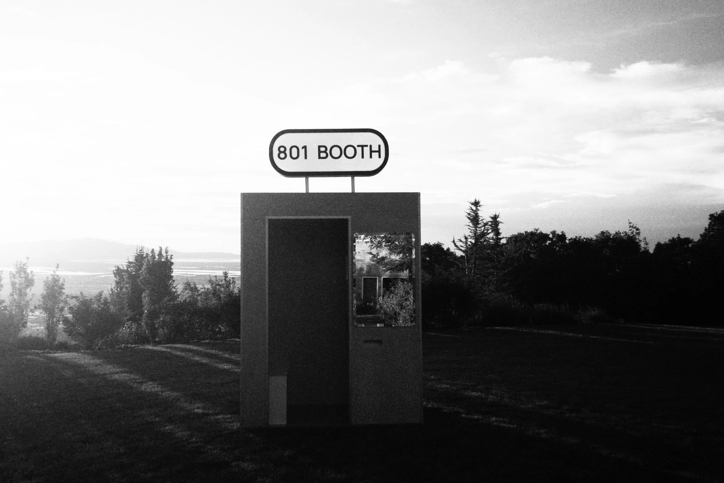 801 Booth's fully enclosed vintage-style photo booth set up outdoors at dusk in Utah