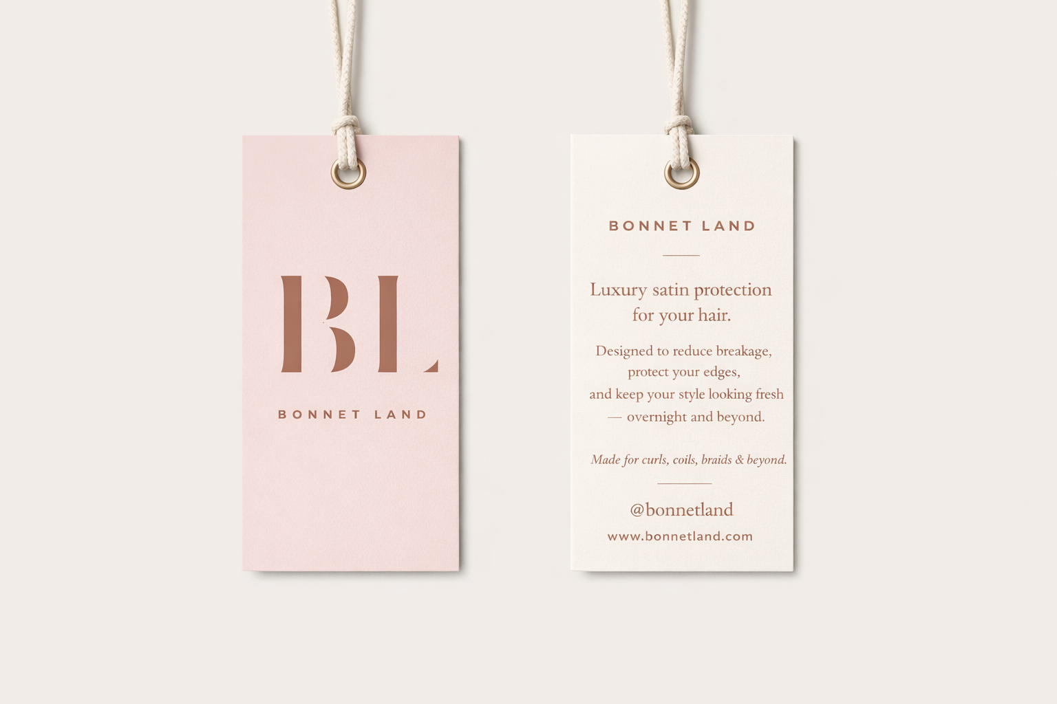 Two tags hanging on white string, one pink with 'BL' and 'Bonnet Land' written on it, the other white with text about hair protection and link.