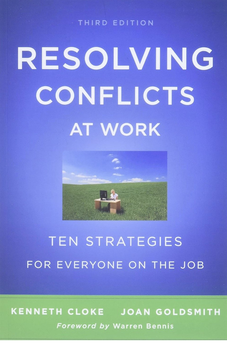 Book cover titled "Resolving Conflicts at Work: Ten Strategies for Everyone on the Job" by Kenneth Cloke and Joan Goldsmith, with a foreword by Warren Bennis. The cover features a woman working at a desk outdoors on grass with a blue sky and white clouds.