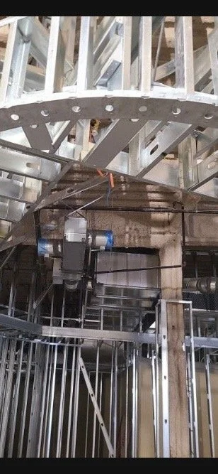 Interior of a building under construction with metal framing and electrical wiring.