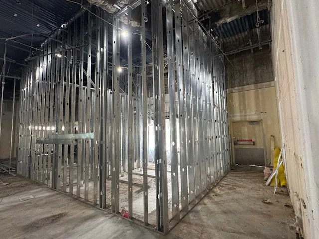 Construction site with metal framing for a new wall or room in progress inside a building.