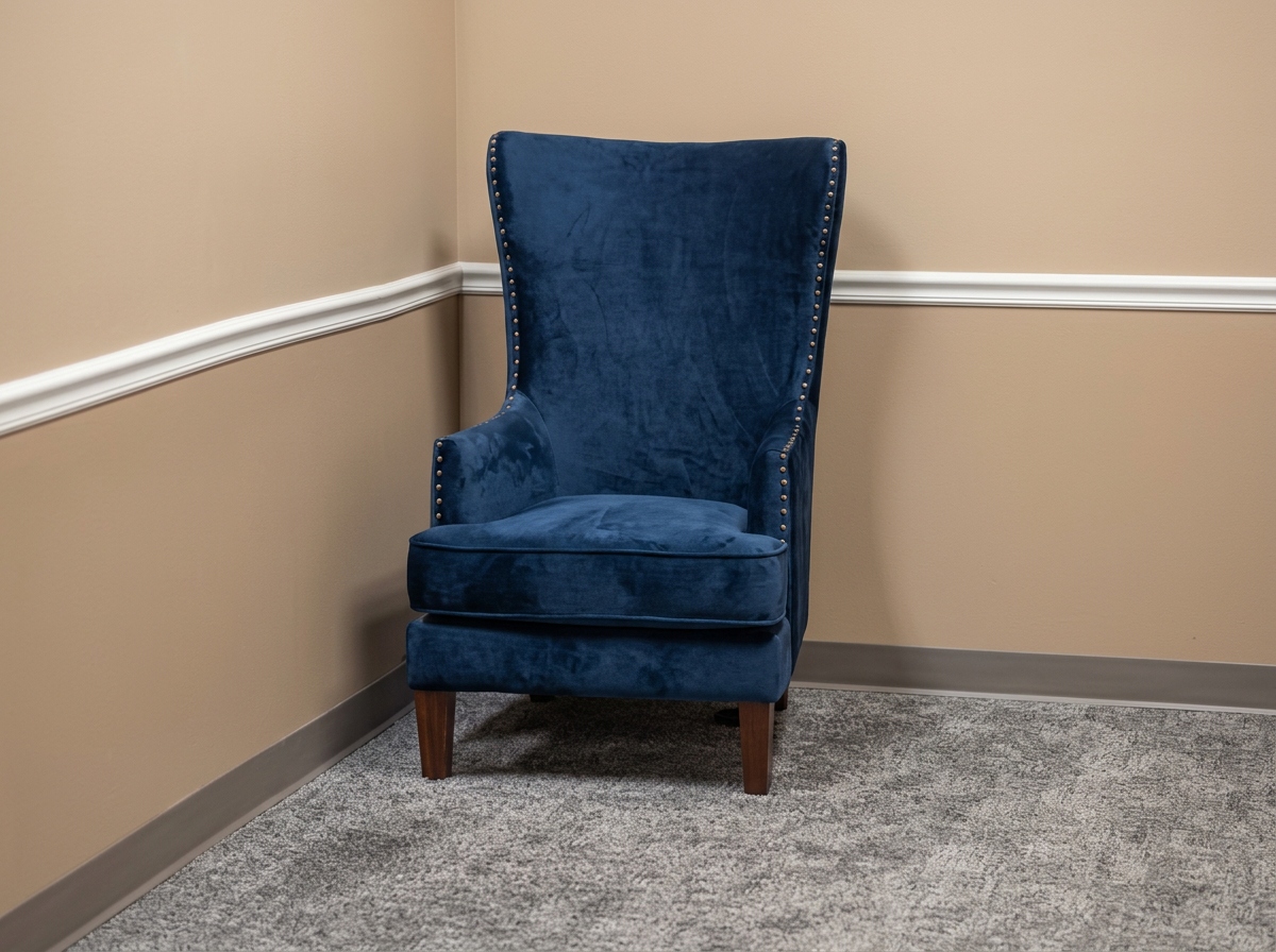Navy wingback chair in a private counseling office in Arlington, TX where individual therapy sessions are held