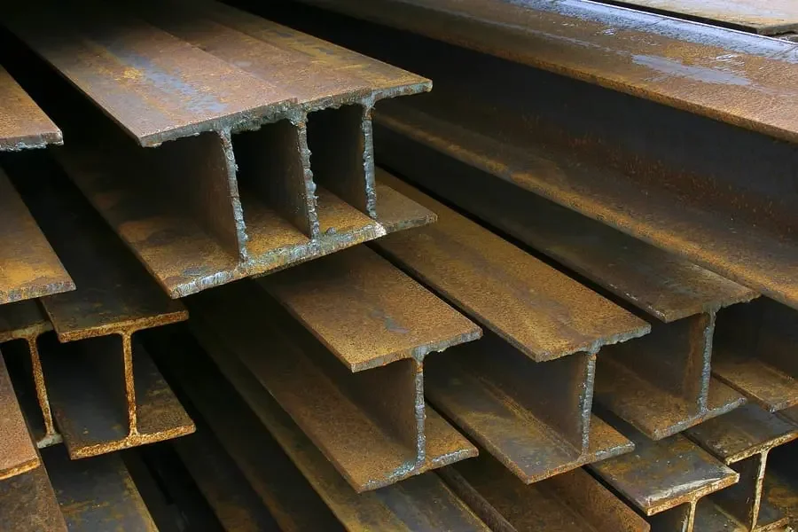 Stack of rusted steel I-beams.