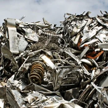 Pile of crushed and twisted metal debris from wrecked vehicles.