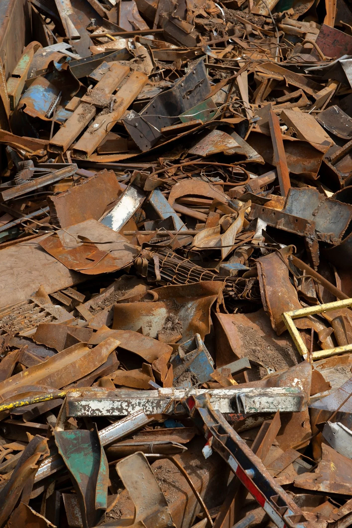 Pile of rusty and weathered scrap metal, including bent and torn sheets, wires, and various metal fragments.