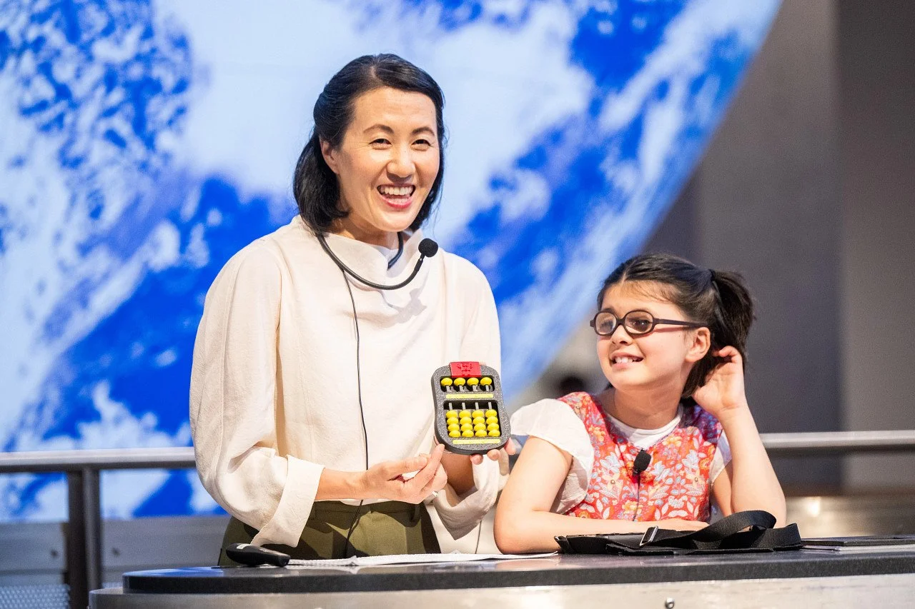 Chi-Hoon Kim (left) and Juniper Eisenberg (right) presenting their book, Juniper and the Red Swoosh at the Boston Museum of Science's 2026 Disability Pride event. Photo © Ashley McCabe