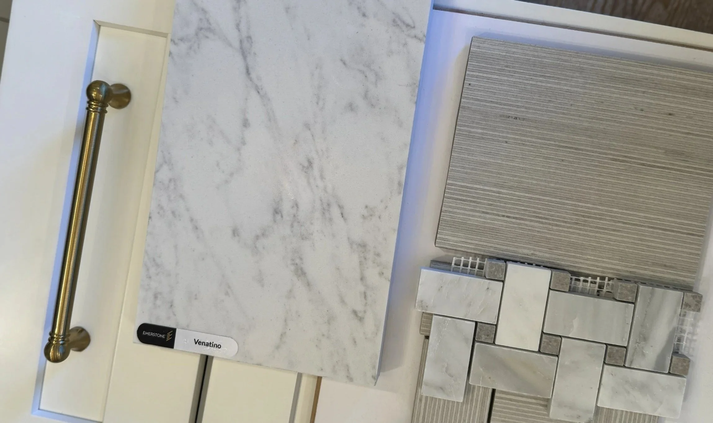 Samples of marble and tile countertop materials displayed on a store wall, including various shades and patterns.