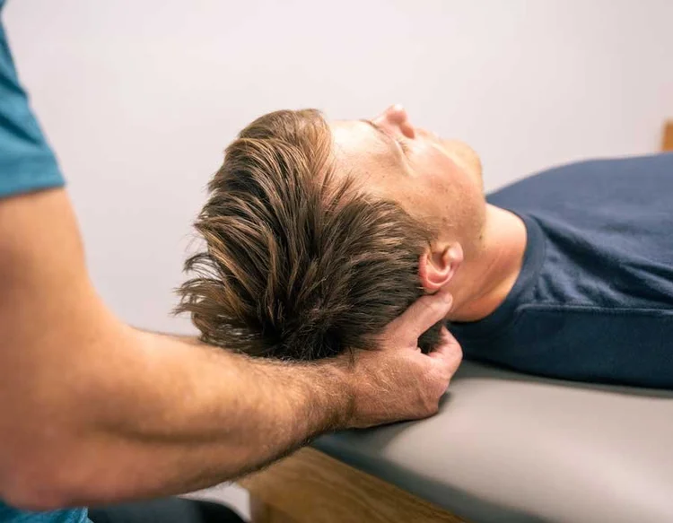 Physical therapist treating neck and back pain at Cascade Physical Therapy in Redding, CA