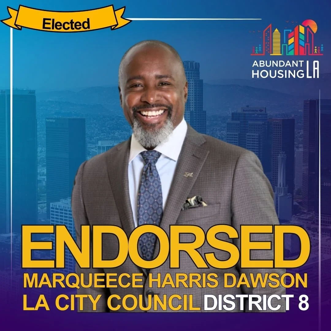 A smiling man in a suit and tie standing in front of a cityscape background. The text on the image indicates he is endorsed for LA City Council District 8, and the campaign is called Abundant Housing LA. The word 'Elected' is highlighted at the top.