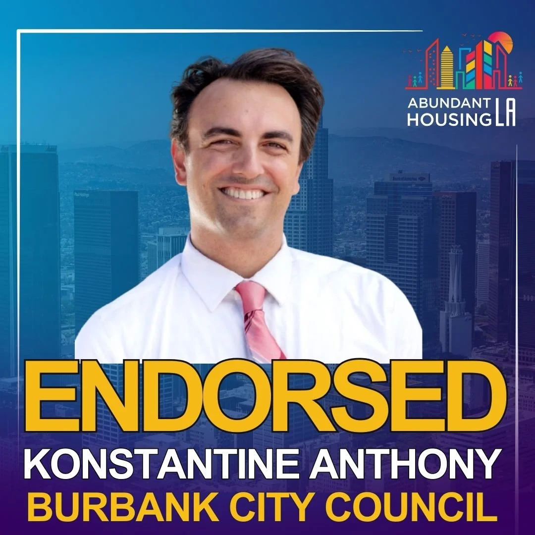 Promotional poster with a smiling man in a white shirt and pink tie in front of a cityscape background. The poster features the text "ENDORSED" in large yellow letters, with additional text "KONSTANTINE ANTHONY" and "BURBANK CITY COUNCIL." The top right corner has a colorful city skyline logo with the text "ABUNDANT HOUSING LA."