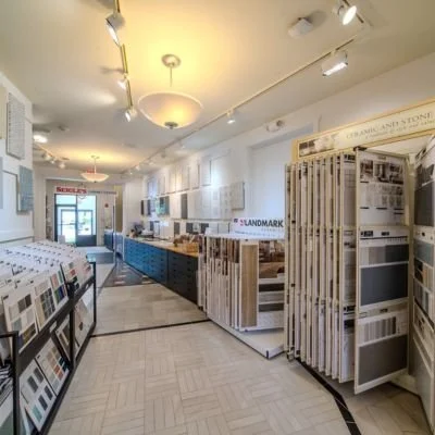 Interior of a flooring or home improvement store displaying various samples of flooring, tiles, and materials on display racks and boards.